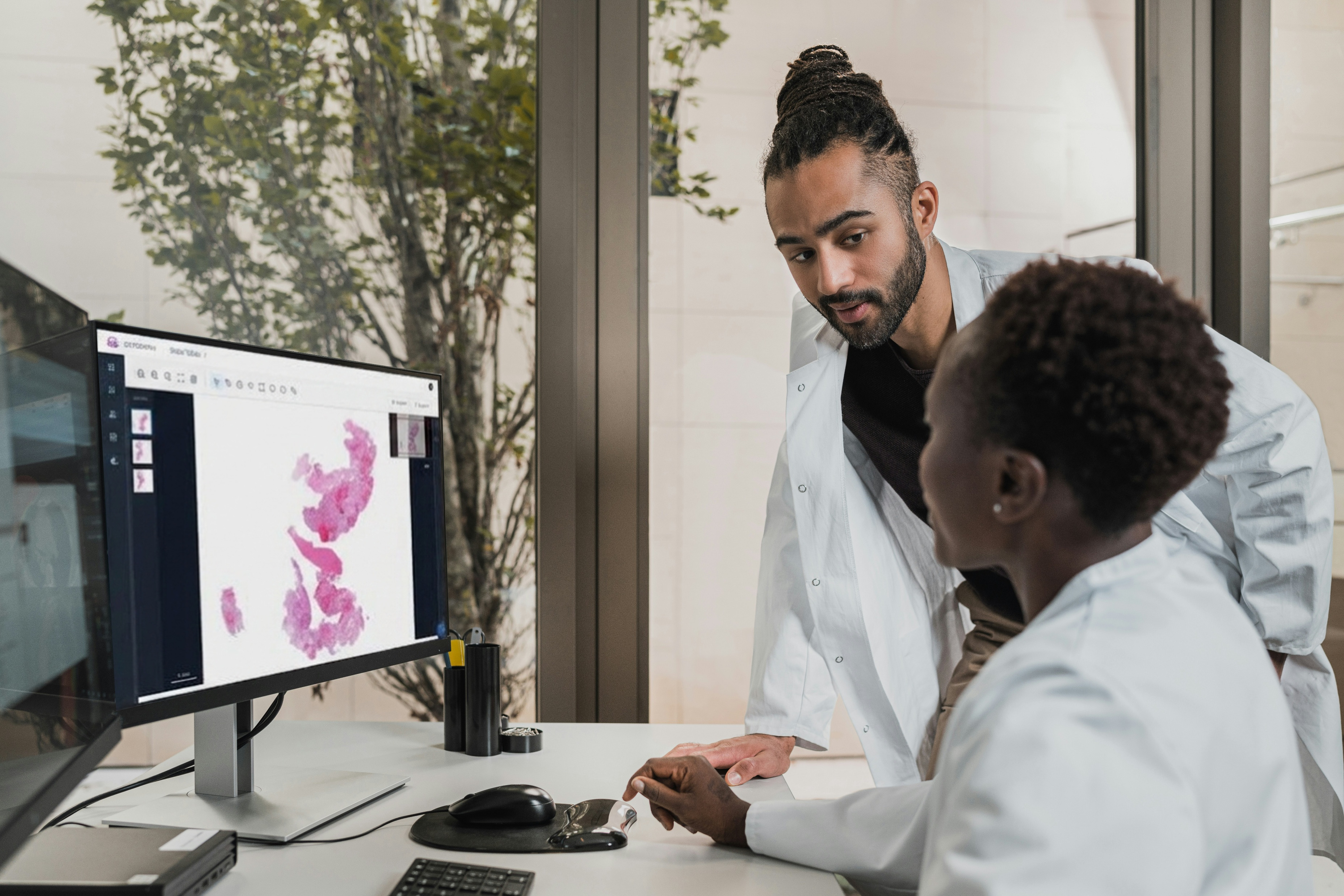 Two clinicians reviewing a case in Compass Platform